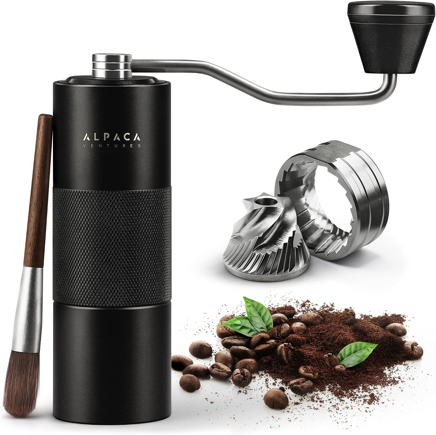 Black Alpaca manual coffee grinder with its knurled grip, cleaning brush, conical burr set and coffee beans